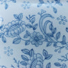 Blue and white pattern depicting intricate flowers and vines as seen on the side of the ceramic urn for ashes.