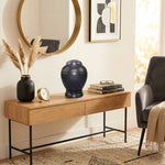 Modern, round black natural marble urn in a home decor setting.