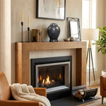Modern, round black natural marble urn on a mantle above a fireplace.