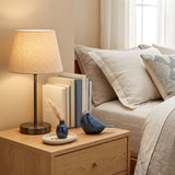 Frost blue songbird cremation keepsake in a home decor setting on a nightstand.