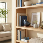 Frost blue songbird cremation keepsake in a home decor setting on a shelf.