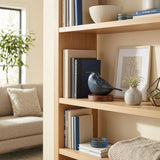 Frost blue songbird cremation keepsake in a home decor setting on a shelf.