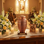 Classic brass urn with a polished copper finish featuring a hand etched leaf design in a funeral service setting.