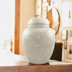 Natural pearl white marble cremation urn in a lifestyle image.
