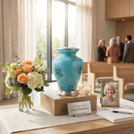 Metal urn with blue and black marbleized finish and pewter accents in a celebration of life setting.