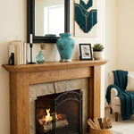 Metal urn with blue and black marbleized finish and pewter accents in a home decor setting above a fireplace