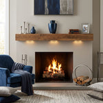 Modern metal urn in a dark blue, shimmery finish with pewter accents in a home decor setting above a fireplace.