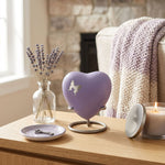 Brass heart keepsake in a light purple finish featuring a pewter butterfly silhouette, displayed in pewter heart standi in a home decor setting.