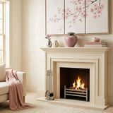 Eastern style brass cremation urn in a pink finish with a pewter lid on a mantle above a fireplace.