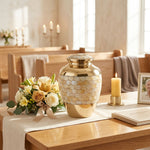 Metal cremation urn with mother of pearl inlay in a funeral service setting.