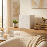 Natural white marble cremation urn with grey veining in a home decor setting.