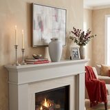 Elegant metal greyish white cremation urn in a home decor setting above a fireplace.