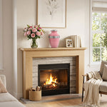 Metal cremation urn in vibrant pink finish with pewter floral band above a fireplace.