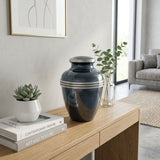 Metal metallic blue banded cremation urn in large in a home decor setting.