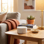 Natural white marble cremation keepsake in a home decor setting on an end table.