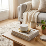 Natural white marble cremation keepsake in a home decor setting on a coffee table.
