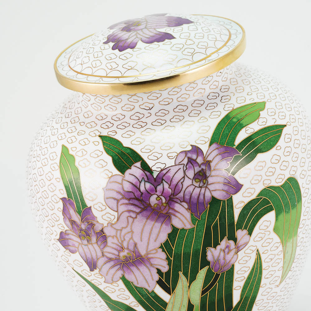 Vibrant white cloisonne cremation urn featuring purple irises with gold accents, detail image.