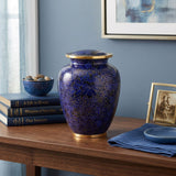 Vibrant blue cloisonne urn featuring a delicate floral motif with gold accents in a modern home decor setting.
