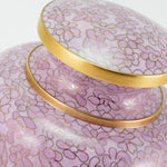 Pink cloisonne cremation urn featuring a floral motif with gold accents, detail image.