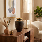 Stunning Black, grey, and onyx cloisonne cremation urn featuring a floral motif with gold accents in a warm, modern home decor setting.