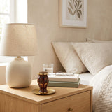 Brown butterfly cloisonne cremation keepsake with gold accents in a home decor setting on a nightstand. 