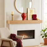 Metal cloisonne urn featuring red and orange leaves and flowers with gold accents in a home decor setting on a mantle.