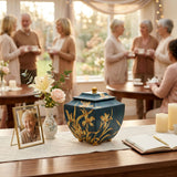 Asian inspired polyresin urn in blue featuring golden orchids in a celebration of life setting.