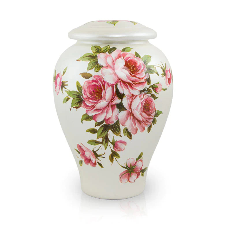 Large white ceramic cremation urn with pink rose bouquet floral design and domed lid