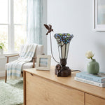 Tiffany styled cremation keepsake lamp that resembles a hummingbird feeding from a flower, with white and blue tones and resin base.