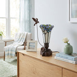 Tiffany styled cremation keepsake lamp that resembles a hummingbird feeding from a flower, with white and blue tones and resin base.