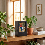 Black photo urn in a home decor setting.