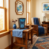 Blue geometric stained-glass cremation urn in a home decor setting.