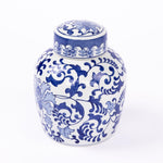 A white ceramic ginger jar urn with a lid, decorated with an intricate blue floral and scroll pattern, set against a plain white background.