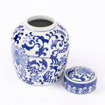 Blue and white ceramic cremation urn with ornate floral pattern and open top
