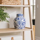 Large ceramic ginger jar cremation urn for ashes with a lovely chinoiserie pattern of blue flowers sitting next on shelf, for perfect memorials to honor your loved one
