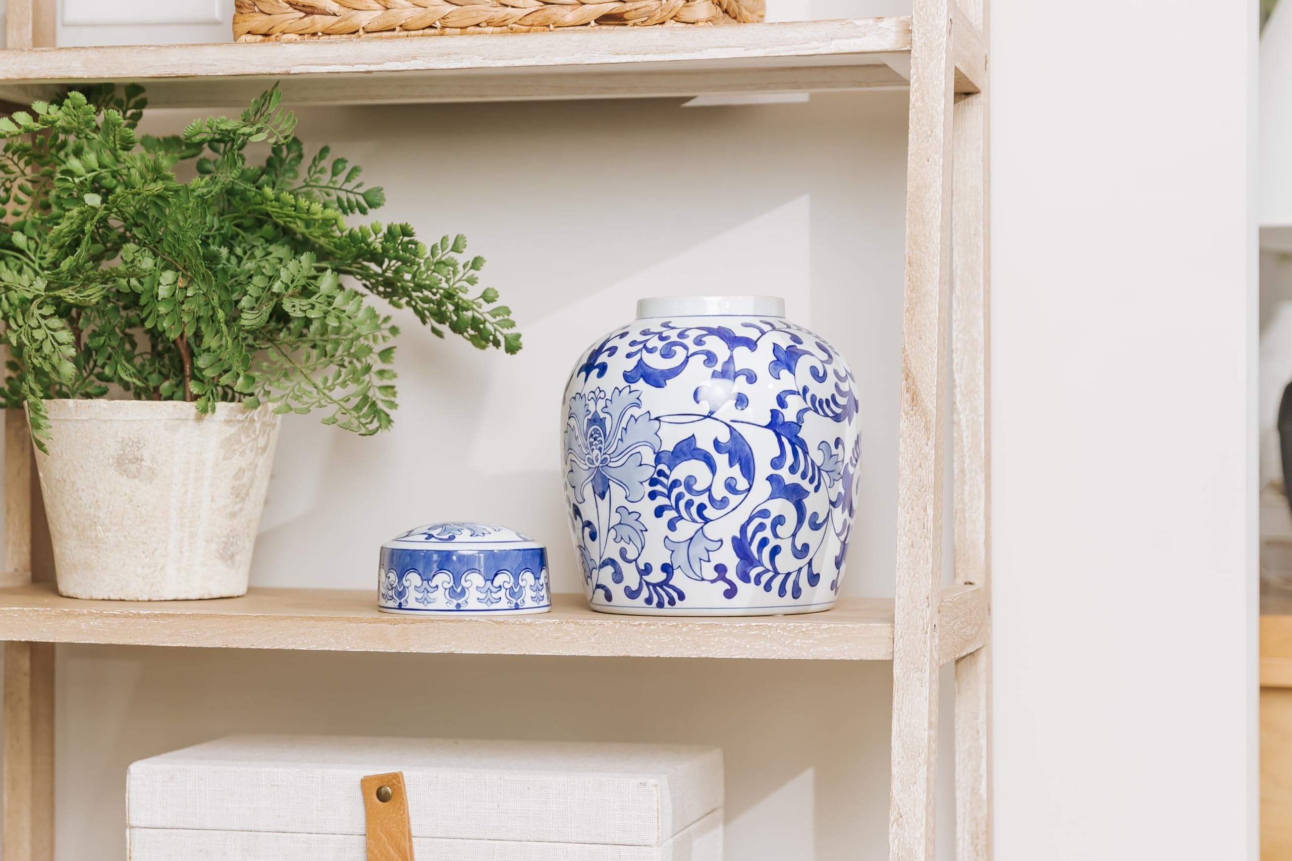 Blue and white ceramic cremation urn with matching lid on display shelf