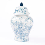 A ceramic ginger jar cremation urn with blue floral chinoiserie design on a white background, including a lid with a blue finial.