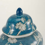 A blue ceramic urn featuring a delicate plum blossom design detail lid image.