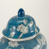 A blue ceramic urn featuring a delicate plum blossom design detail lid image.