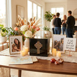 Natural black marble box urn with hand crafted gold celtic cross and pink shell inlay in a celebration of life setting.