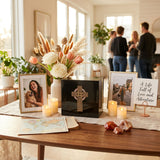 Natural black marble box urn with hand crafted gold celtic cross and pink shell inlay in a celebration of life setting.