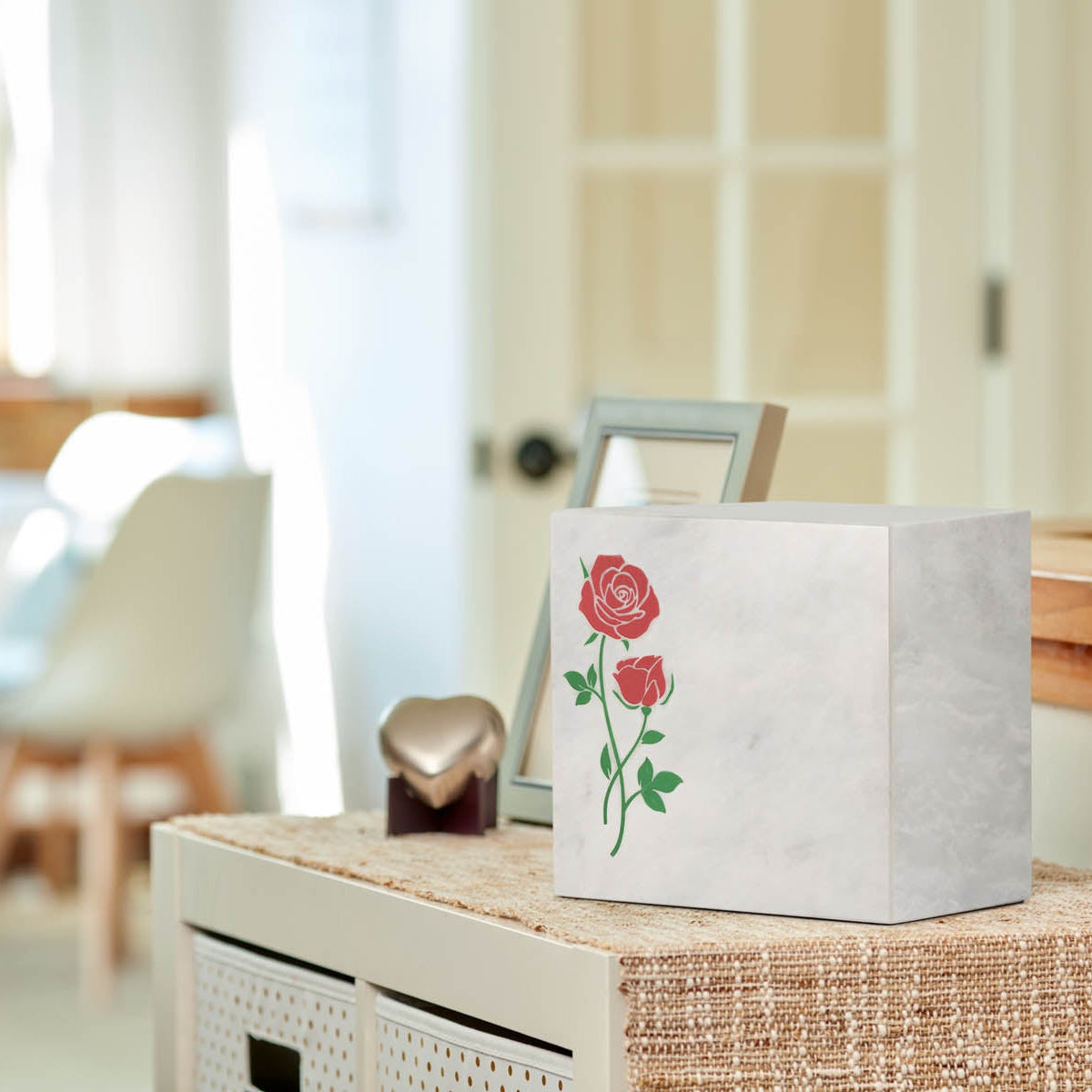 White marble box urn with hand crafted red roses lifestyle.