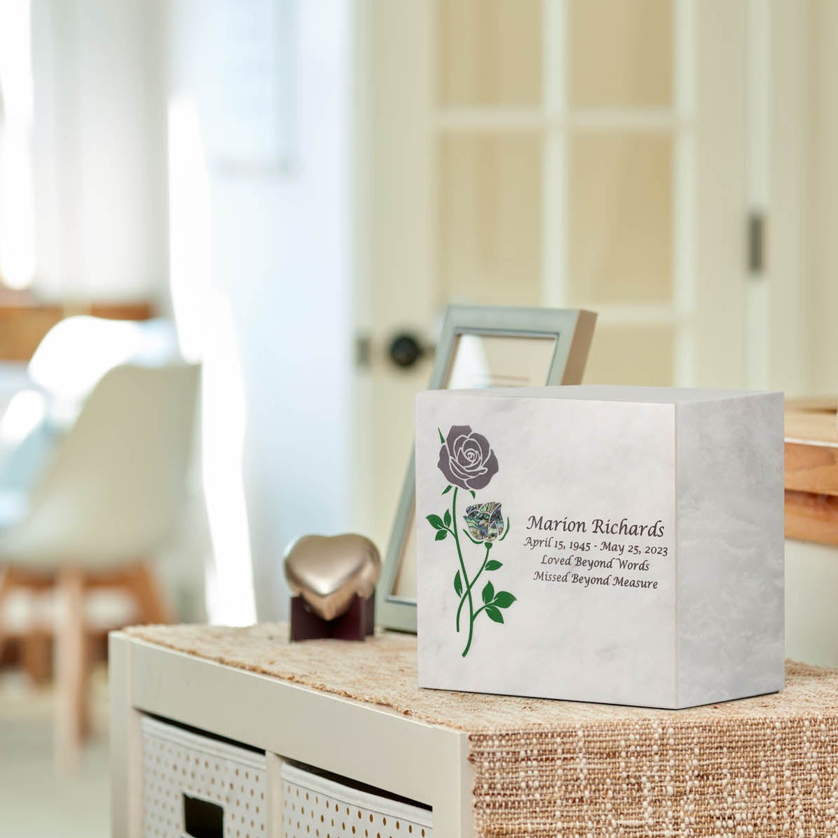 Natural white marble box urn with handcrafted rose design and blue shell inlay lifesyle.