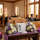 Natural white marble cremation urn with handcrafted plum rose design and blue shell inlay in a funeral service setting.