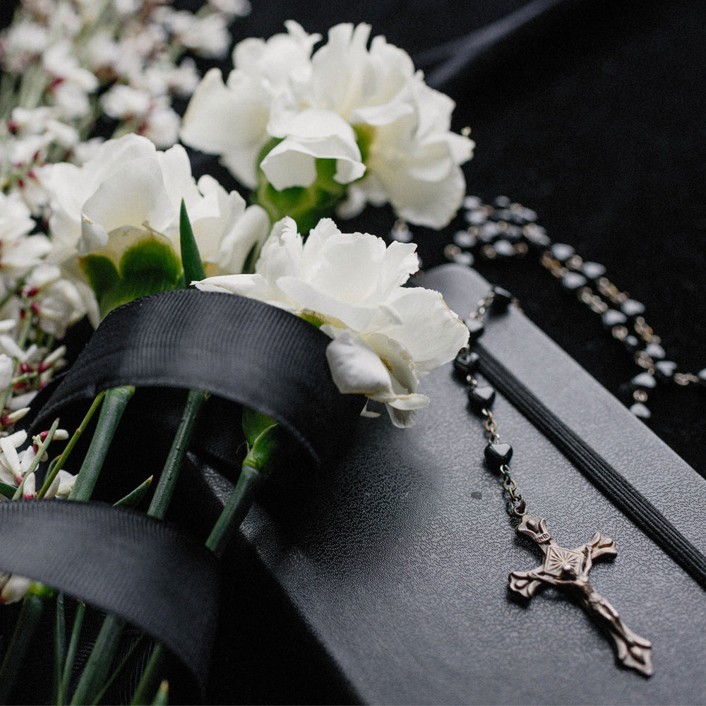 rosary with white flowers for memorial