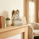 Weeping angel cremation urn in a home decor setting on a mantle.