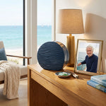 Modern blue ceramic urn featuring a dimensional tranquil wave design in a home decor setting.