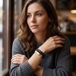 Women's braided leather bracelet with gold accents.