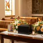 Natural black marble cremation urn in a modern shape in a funeral service setting.