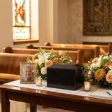 Natural black marble cremation urn in a modern shape in a funeral service setting.